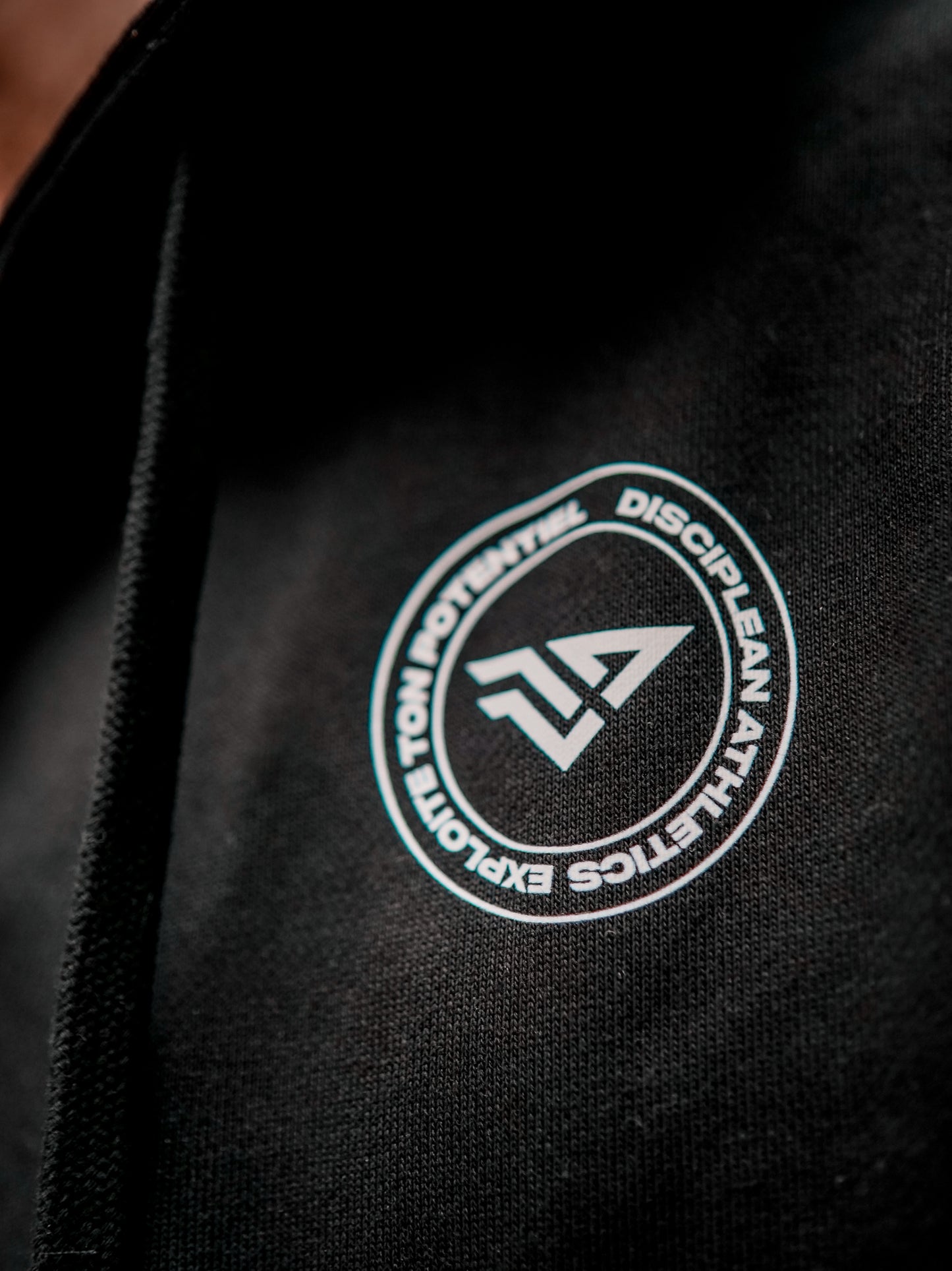 Vue rapprochée du devant d'un sweat avec zip de musculation noir Disciplean