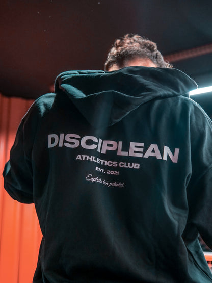 Homme de dos en salle de musculation portant un sweat avec zip noir Disciplean